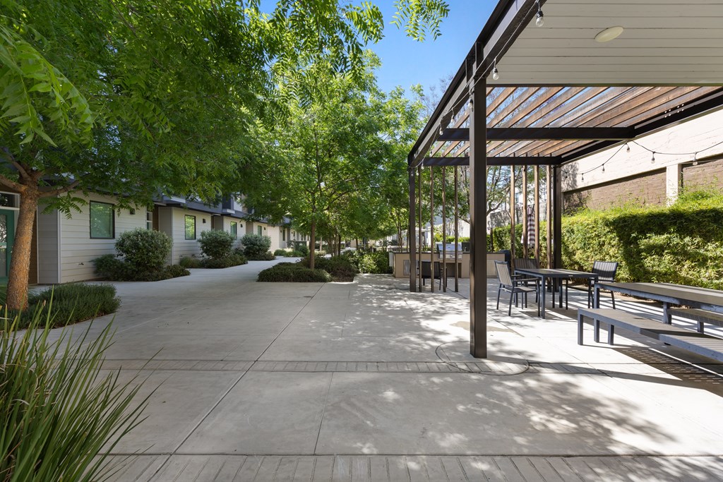 A sunny day at the outdoor seating area of a modern building.